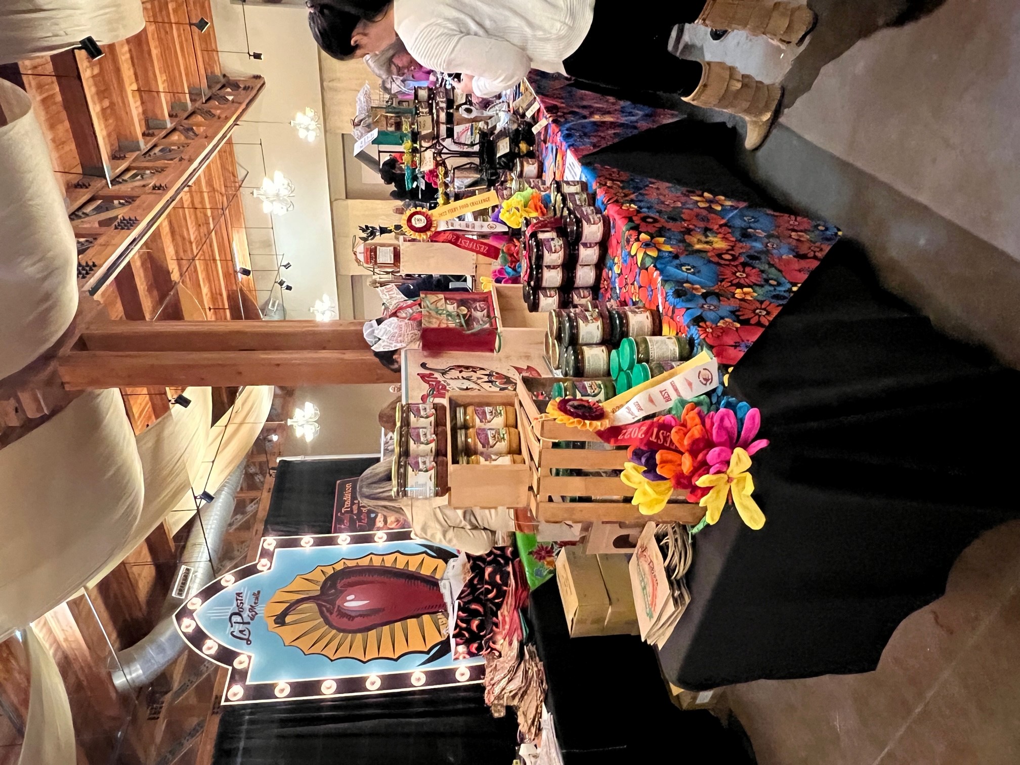 A colorful booth selling different products in jars. 