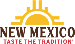 New Mexico Taste the Tradition Logo. A Sun over the horizon with the words New Mexico acting as the horizon with yellow bars coming out of the sides. Below are the words Taste the Tradition in red.