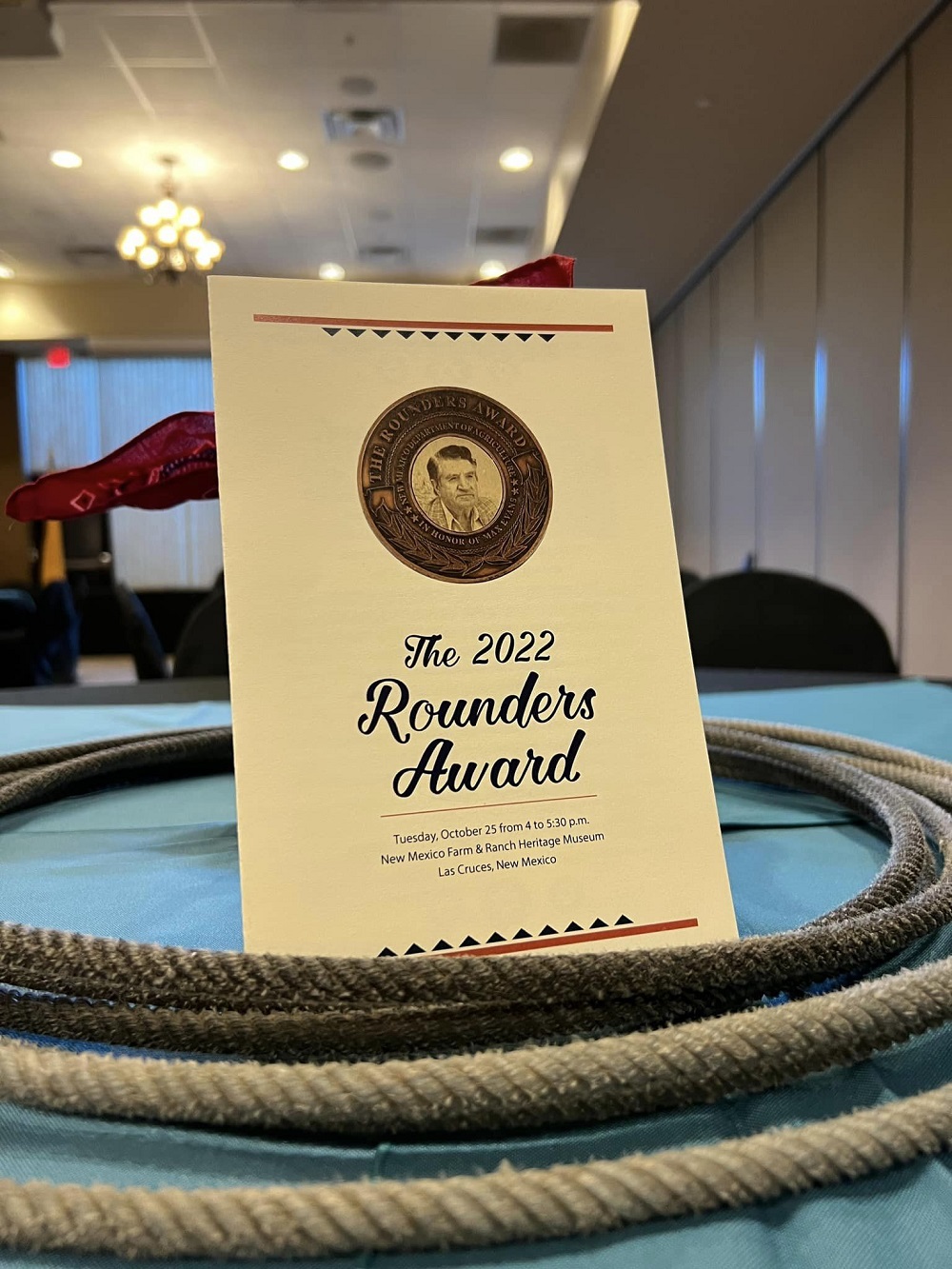 a flyer in the middle of a lasso rope on a table. the flyer says the 2022 rounders award.