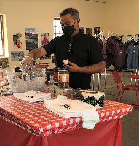 a fairgoer receiving a free sample from the country store. 