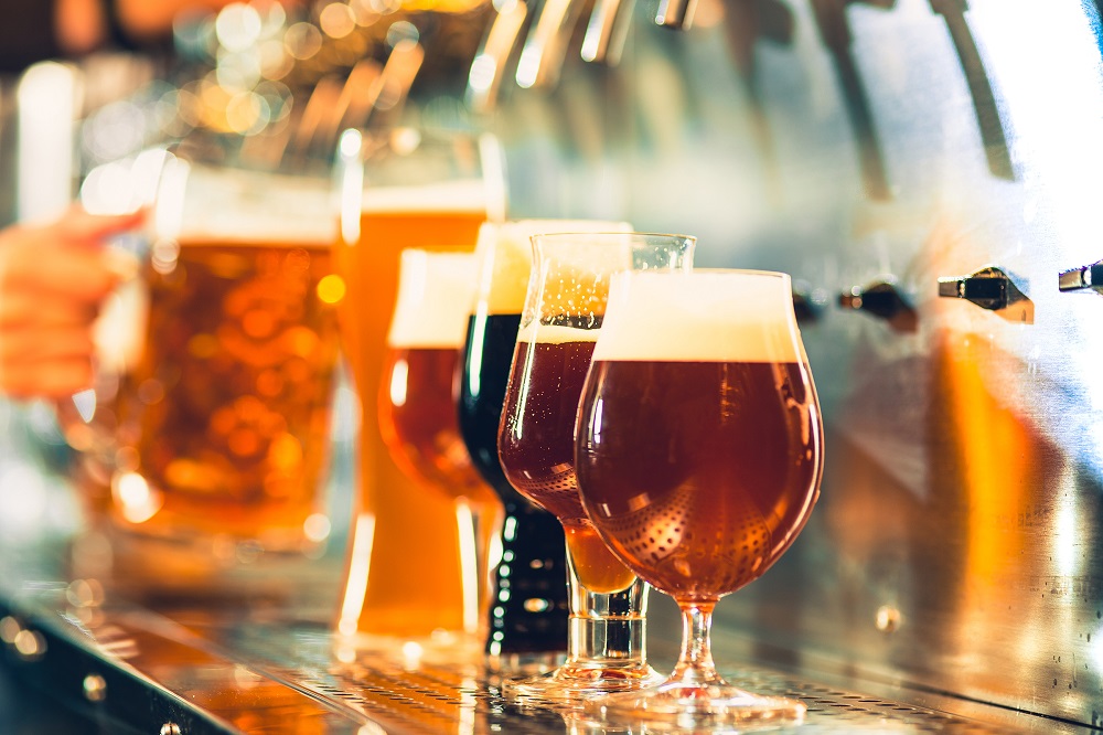 Glasses of draft beer being filled.